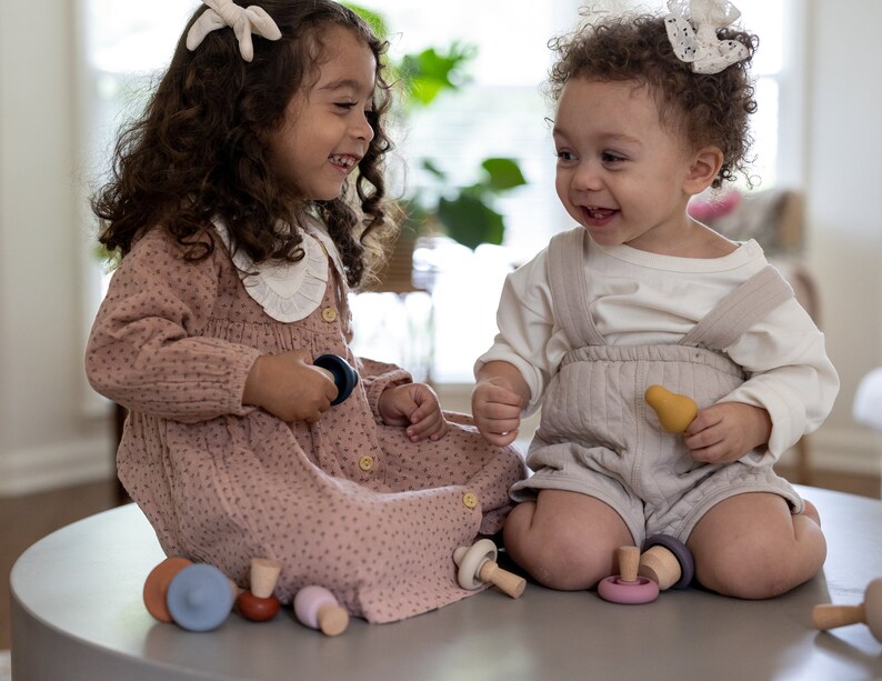 Child stacking and matching Montessori mushroom toy pieces