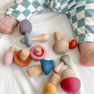 Toddler playing with Montessori mushroom mix and match toy