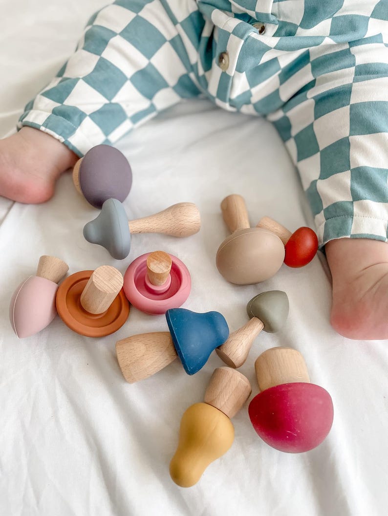 Toddler playing with Montessori mushroom mix and match toy