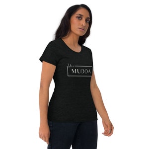 May include: A black t-shirt with a white graphic that says "Like a MUDDA" in a rectangular box.