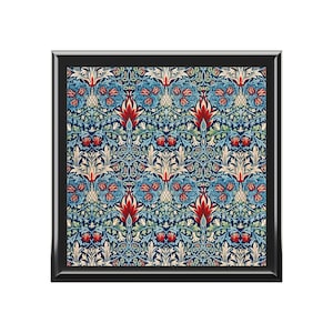 May include: A framed print of a vintage floral pattern with red, blue, and green colors. The pattern features a repeating design of stylized flowers and leaves.