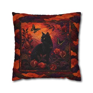 May include: A square throw cushion featuring a quilted design with a central scene of a black cat sitting among pomegranates and two butterflies. The colour palette includes deep shades of orange, red, purple, and black with intricate stitching.