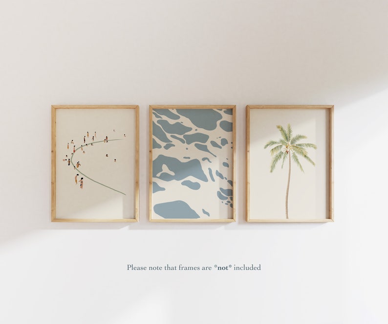 May include: Three framed prints with a beach theme. The left print shows a group of people on a beach, the middle print shows a blue and white abstract pattern, and the right print shows a palm tree.