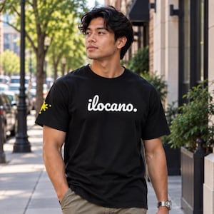 May include: A black short-sleeved t-shirt featuring the white text ilocano. printed on the chest and a small yellow sun and star graphic on the right sleeve. The shirt has a crew neckline and a standard fit.