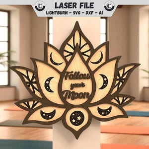 May include: Wooden lotus flower wall art with the text "Follow your Moon". The layered design features a light wood centre with dark brown edges and crescent moon and star cutouts. The laser-cut design is displayed in a yoga studio.