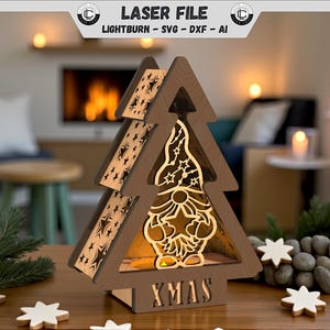 May include: Wooden Christmas tree-shaped light-up decoration with a gnome design inside. The tree has star cutouts and the word "XMAS" at the base. The top banner reads "LASER FILE".