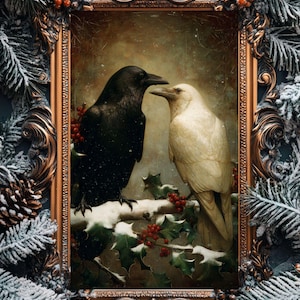 May include: An ornate framed print features two ravens, one black and one white, perched on a snow-covered branch with holly and red berries. The frame is gold with intricate detailing, surrounded by frosted pine branches.