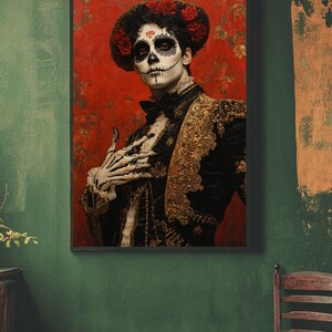 May include: Framed portrait of a person in Day of the Dead attire. The person has skull face paint, a black outfit with gold embroidery, and a hat with red roses. The background is a textured red.