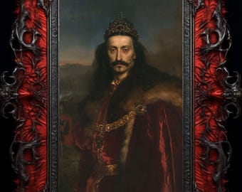 May include: A portrait of a person with long dark hair and a mustache, wearing a crown, a red velvet robe with fur trim, and a gold chain. The portrait is encased in an ornate, dark, gothic-style frame with deep red fabric accents.