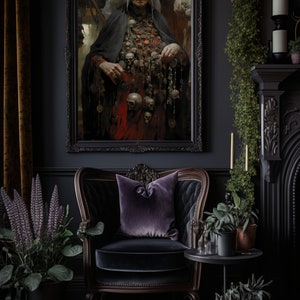 May include: A dark, moody interior with a framed painting of a woman wearing a white head covering and a long black robe. She is adorned with a necklace of skulls and other trinkets. The painting is hanging on a dark wall, and there is a black velvet armchair in the foreground. The room is decorated with plants and candles.