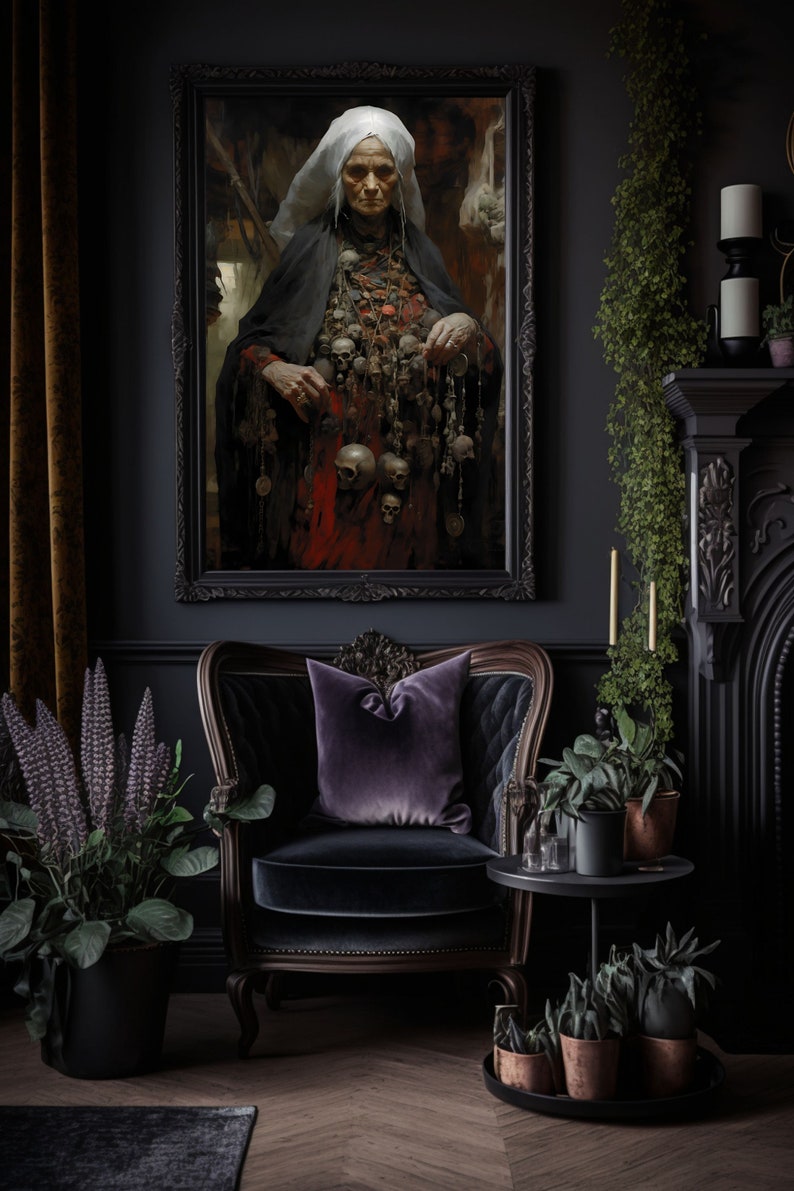 May include: A dark, moody interior with a framed painting of a woman wearing a white head covering and a long black robe. She is adorned with a necklace of skulls and other trinkets. The painting is hanging on a dark wall, and there is a black velvet armchair in the foreground. The room is decorated with plants and candles.