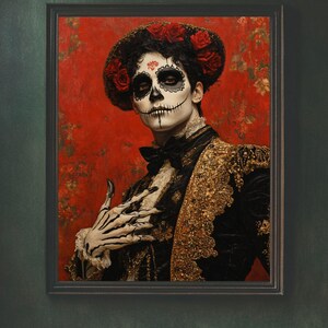 May include: Framed portrait of a person in Day of the Dead attire. The person wears a black jacket with gold embroidery, a black bow tie, and a floral headpiece. The face is painted with a skull design against a red floral background.