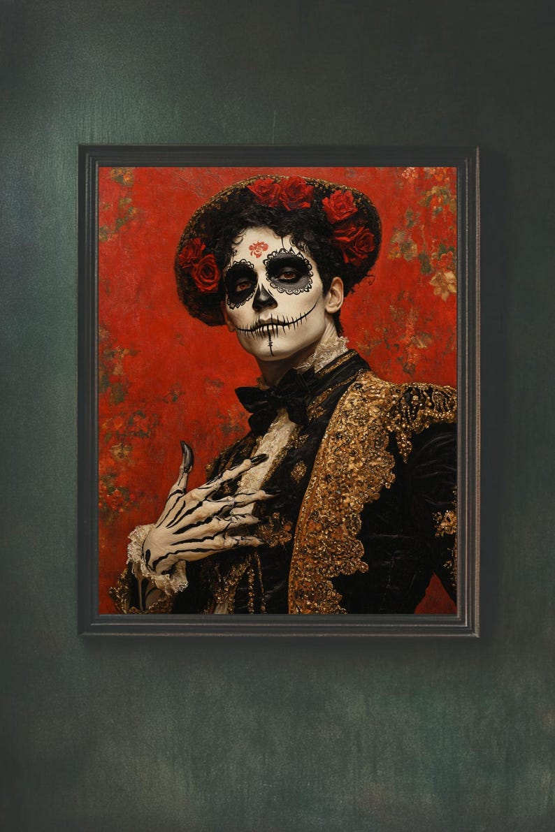 May include: Framed portrait of a person in Day of the Dead attire. The person wears a black jacket with gold embroidery, a black bow tie, and a floral headpiece. The face is painted with a skull design against a red floral background.