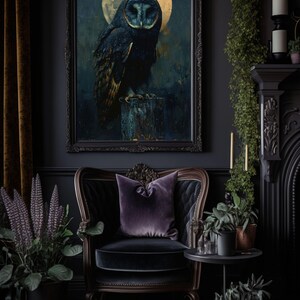 May include: A dark room with a black velvet armchair, a side table, and a framed print of an owl perched on a branch under a full moon. The room is decorated with plants and candles.