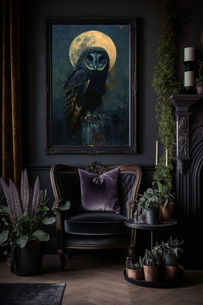 May include: A dark room with a black velvet armchair, a side table, and a framed print of an owl perched on a branch under a full moon. The room is decorated with plants and candles.
