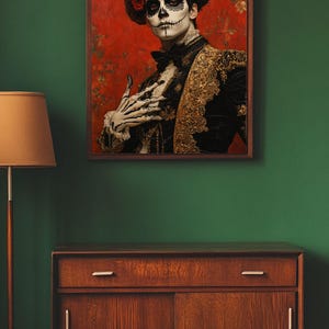 May include: A framed portrait depicting a person in Day of the Dead attire. The person has skull face paint, a black jacket with gold detailing, and a red rose headdress. The background is red with floral patterns.