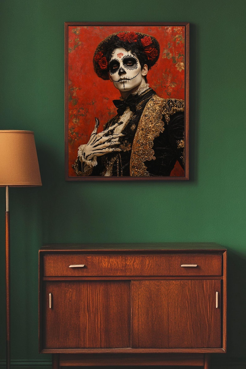 May include: A framed portrait depicting a person in Day of the Dead attire. The person has skull face paint, a black jacket with gold detailing, and a red rose headdress. The background is red with floral patterns.