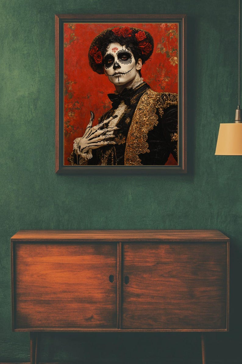 May include: A framed portrait depicting a person in Day of the Dead makeup and attire. The person wears a black jacket with gold detailing, a bow tie, and a floral headpiece. The background is red with floral patterns.