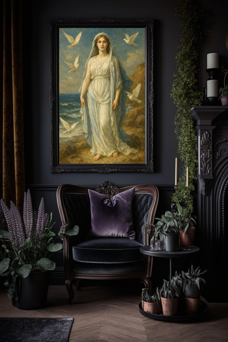May include: A framed painting of a woman in a white dress standing on a beach with doves flying around her. The painting is set against a dark gray wall with a black velvet armchair and a side table with potted plants.