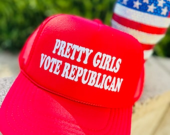 May include: Red trucker hat with a white mesh back. The hat has white text that reads "Pretty Girls Vote Republican."