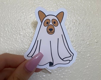 May include: A white ghost with a brown dog face and ears. The ghost is outlined in black and has a white background.