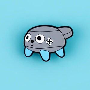 May include: A gray enamel pin shaped like a cartoon creature with a rounded body, large white eyes with black pupils, a small black nose, and a black mouth. The creature has three light blue legs and a black plus sign symbol on its side.