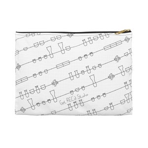 May include: White zippered pouch with a black and white repeating pattern of musical notes and a handwritten inscription that says "Get REC'd Studio".