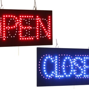 Puede incluir: Dos letreros LED, uno rojo con la palabra "ABIERTO" y otro azul con la palabra "CERRADO". Ambos letreros tienen una cadena para colgar.