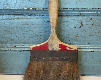 Old big paintbrush with wooden handle 50’