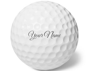 Può includere: Una palla da golf bianca con il testo "Your Name" stampato su di essa.