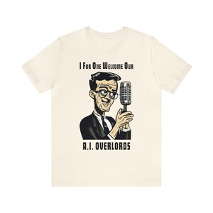 May include: A white t-shirt with a cartoon illustration of a man in a suit holding a microphone. The text "I For One Welcome Our A.I. Overlords" is printed on the shirt.