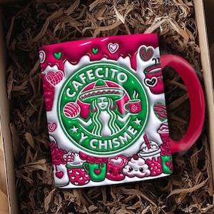 May include: A ceramic coffee mug with a red handle and rim, featuring a green and white design with the words "Cafecito y Chisme." The mug is decorated with hearts, coffee cups, and other festive elements. It is presented in a brown cardboard box with shredded paper.