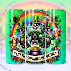 May include: Three green and white skeleton figures wearing green hats and holding beer mugs. The skeletons are standing in front of a rainbow and green shamrocks. The text "Let the Shenanigans Begin!" is written on a banner below the skeletons.