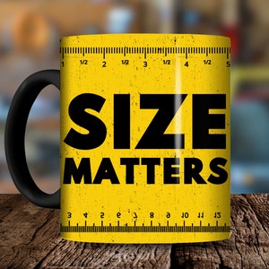Puede incluir: Taza de café de cerámica amarilla con asa negra. La taza tiene una regla impresa en el lateral y el texto "SIZE MATTERS" en letras negras.