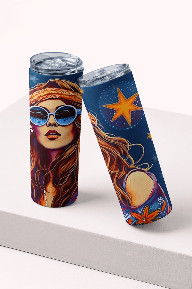 May include: Two stainless steel tumblers with a colorful design featuring a woman with long brown hair wearing sunglasses and a headband. The design also includes a large yellow star and other stars on a blue background.