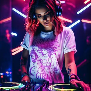 May include: A person wearing headphones and a white t-shirt with the text "Girls Will Be Girls" and a graphic of a woman holding a sword and a severed head. The person is at a DJ setup with colorful lights.