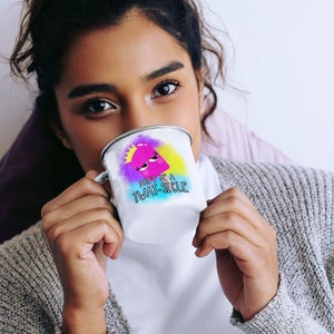 May include: A white enamel mug with a colorful graphic of a pink cartoon character with a crown and the text "Don't be a Twat-sicle".