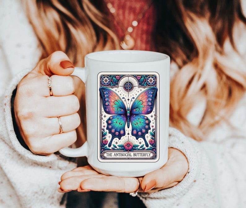 May include: White ceramic mug with a colorful butterfly illustration and the text "The Antisocial Butterfly".