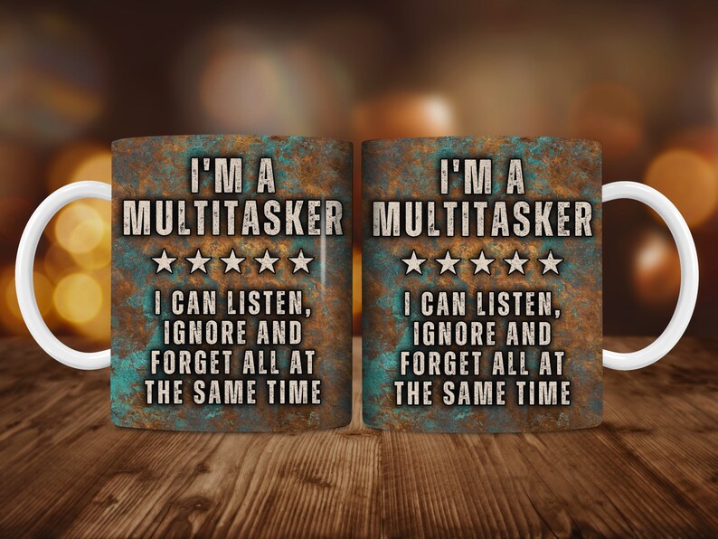 May include: Two white ceramic mugs with a rustic, metallic blue and brown design. The mugs feature the text "I'm a Multitasker" with five stars and the text "I can listen, ignore and forget all at the same time".