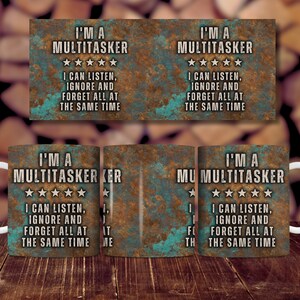 May include: A white ceramic mug with a rusty metal design. The mug features the text "I'm a Multitasker" with five stars and the text "I can listen, ignore and forget all at the same time".