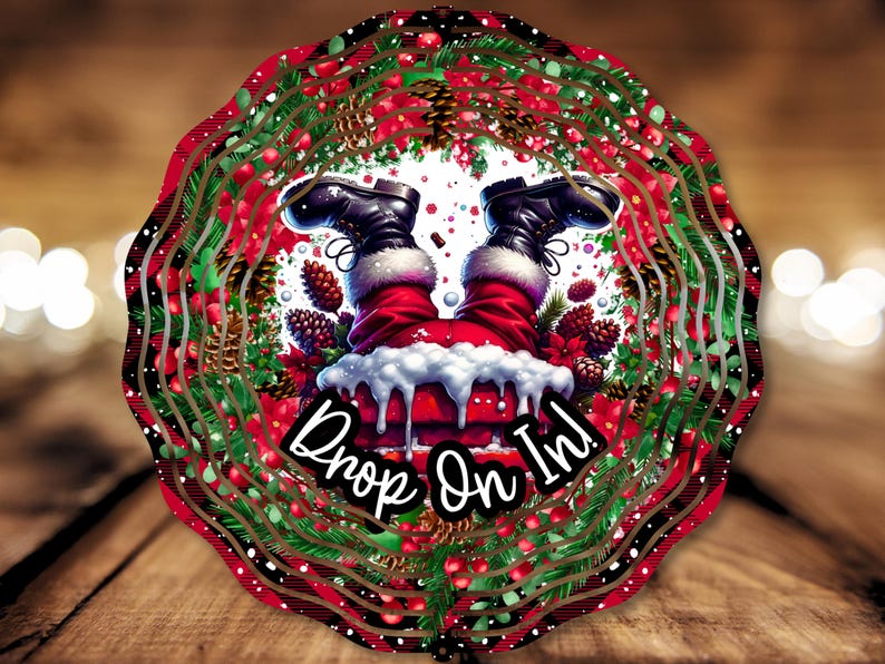 May include: A Christmas-themed wreath with a red and green color scheme. Santa Claus's legs are sticking out of a chimney, with the text "Drop On In!" below.