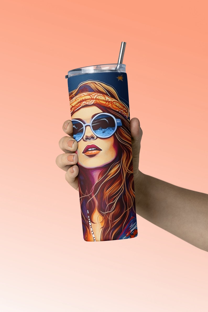 May include: A stainless steel tumbler with a colorful illustration of a woman with long brown hair wearing sunglasses and a headband. The tumbler has a straw.