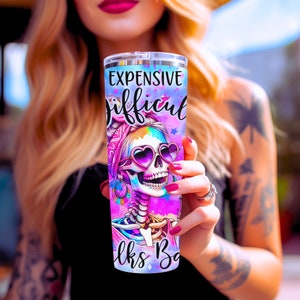 May include: A pink and blue stainless steel tumbler with a colorful skull design and the text "Expensive Difficult Looks Bad".