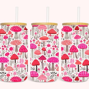 May include: Three stainless steel tumblers with bamboo lids and pink and white mushroom patterns. Each tumbler has a straw.