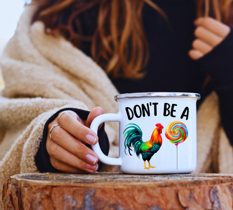 May include: White enamel mug with a black and white rooster and a colorful lollipop with the text "Don't be a" on the front.