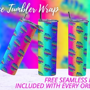 May include: Three stainless steel tumblers with a rainbow ombre design and a tropical leaf pattern. The tumblers are on a white surface with a blurred background. Free Seamless PNG Included with Every Order!