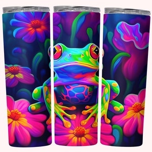 May include: A stainless steel tumbler with a colorful frog sitting on a flower. The frog is green, blue, yellow, and orange. The flowers are pink and purple. The background is dark blue.