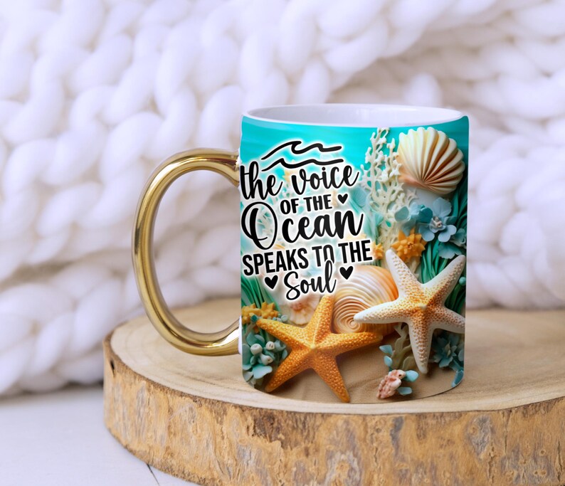 May include: White ceramic mug with a gold handle. The mug features a blue and green ocean scene with seashells, starfish, and the text "the voice of the ocean speaks to the soul".