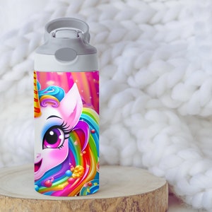May include: A white water bottle with a gray lid and a colorful unicorn design. The unicorn has a pink body, blue mane, and rainbow tail. The background is a pink and purple galaxy with stars.