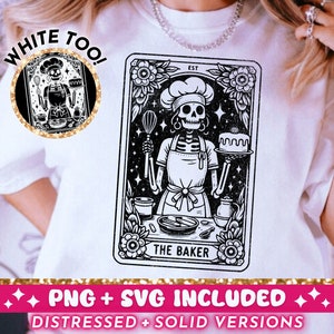 May include: A white t-shirt with a black and white illustration of a skeleton baker holding a cake and a whisk. The illustration is in the style of a tarot card and says "The Baker" at the bottom. The text "White Too!" is in a circle above the illustration.